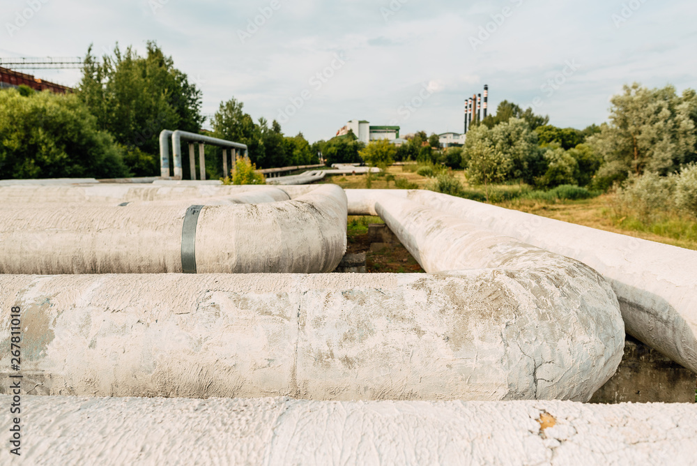 Metal pipes in the field. gas pipeline for pumping gas. heat pipe. big pipe for hot water pipeline Metal pipes in the field. gas pipeline for pumping gas. heat pipe. big pipe for hot water pipeline