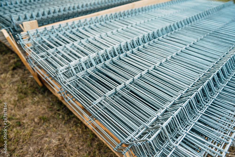 Shiny polished metal construction grid, folded in flat pile, poured into cold metallic shades, fittings, wire. Shiny polished metal construction grid, folded in flat pile, poured into cold metallic shades, fittings, wire.