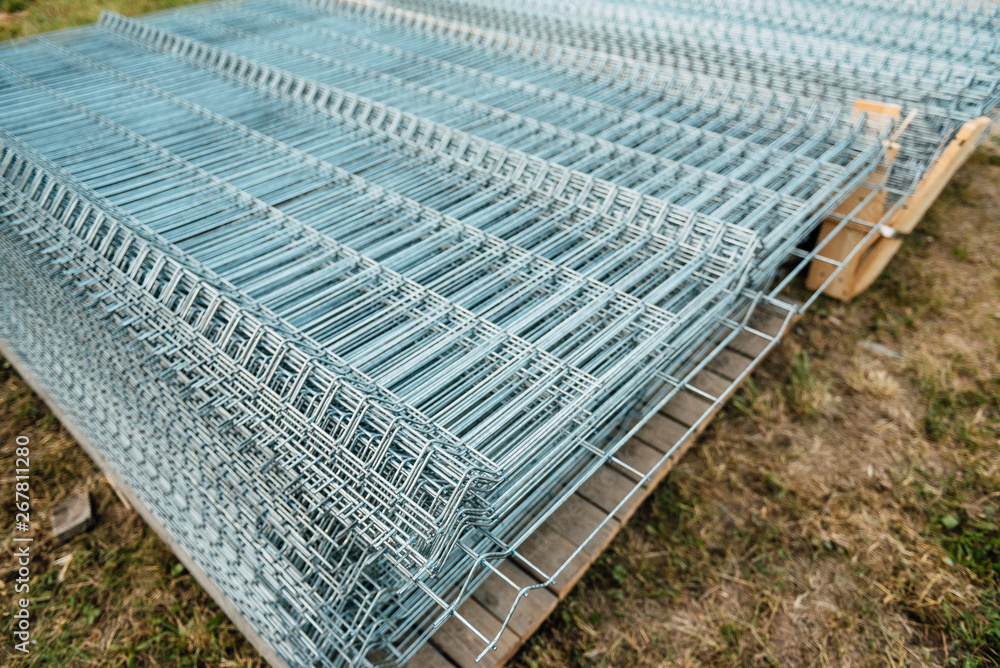 Shiny polished metal construction grid, folded in flat pile, poured into cold metallic shades, fittings, wire. Shiny polished metal construction grid, folded in flat pile, poured into cold metallic shades, fittings, wire.