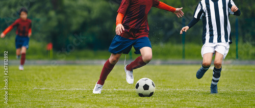 Soccer football players chasing ball on field © matimix