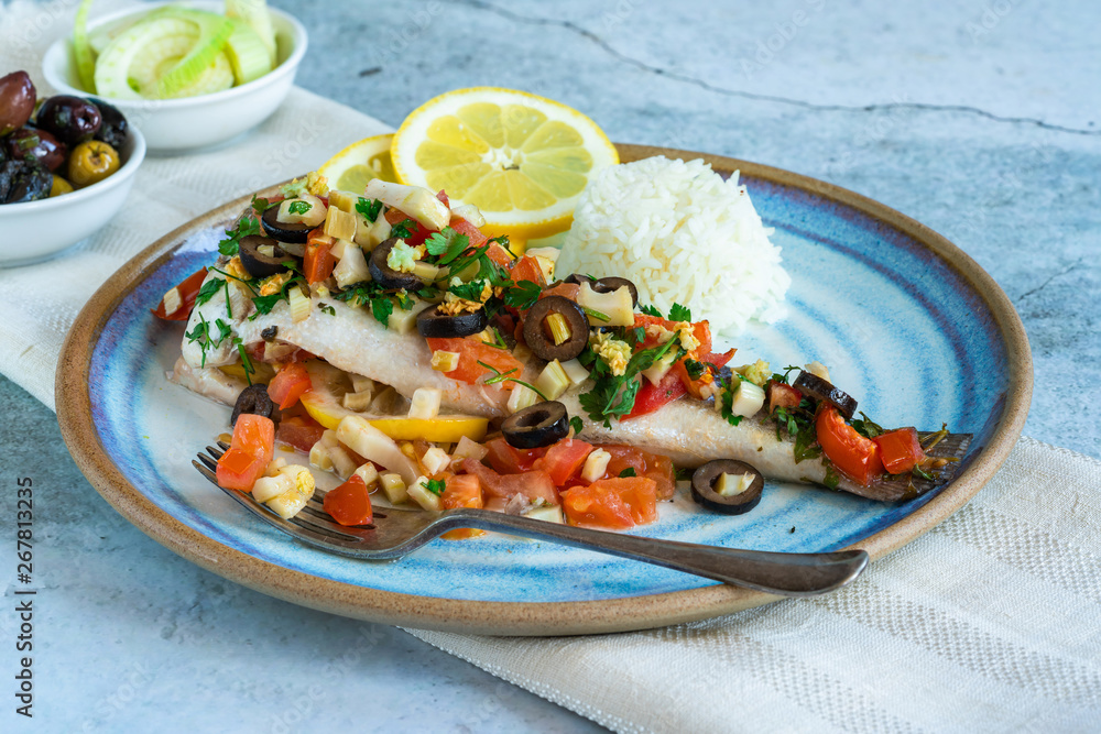 Mediterranean sea bass stuffed with tomatoes, lemons, fennel and olives. Greek cuisine. Mediterranean sea bass stuffed with tomatoes, lemons, fennel and olives. Greek cuisine.