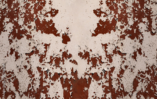 Rusty metal wall, old iron sheet, covered with rust with multi-colored paint. Trace of remnant of old paint in large deep crack on texture of surface rusty metal. Background texture old paint on metal