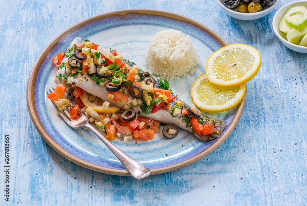Mediterranean sea bass stuffed with tomatoes, lemons, fennel and olives. Greek cuisine. Mediterranean sea bass stuffed with tomatoes, lemons, fennel and olives. Greek cuisine.