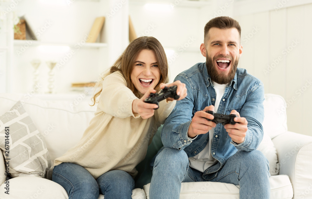 Crazy Couple Enjoying Playing Videogame On Playstation Crazy Couple Enjoying Playing Videogame On Playstation