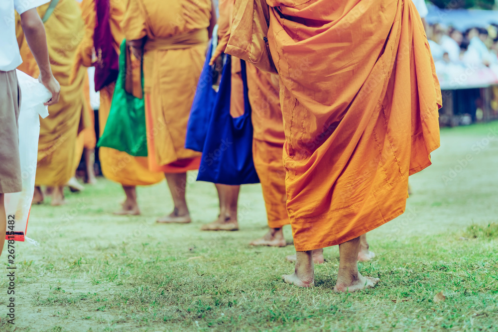 Teachers and students together make merit to give food offerings to a Buddhist monk on important religious days at school. Teachers and students together make merit to give food offerings to a Buddhist monk on important religious days at school.