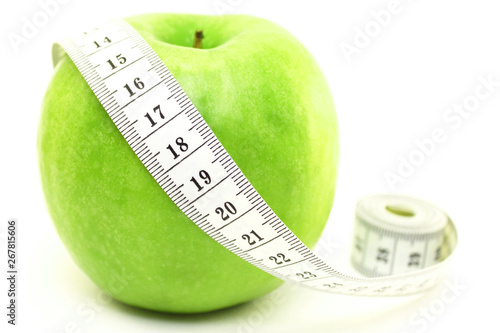 Perfect green apple with measuring tape isolated on white background as abstract symbol of diet, vegetarianism and veganism