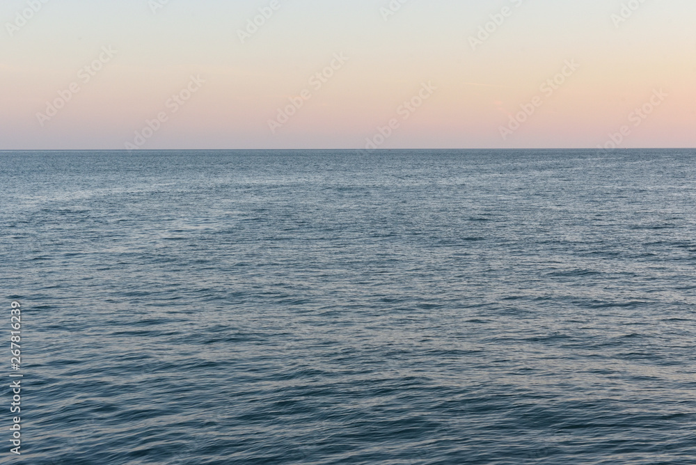 Evening landscape of the Black Sea, calm water and the evening sky in the city of Gelendzhik, Russia Evening landscape of the Black Sea, calm water and the evening sky in the city of Gelendzhik, Russia