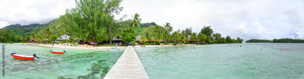 Wooden Walkway, Dock on tropical beach, clear water, Moorea, Tahiti French Polynesia. Panoramic Photo