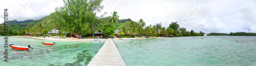 Fototapeta Naklejka Na Ścianę i Meble -  Wooden Walkway, Dock on tropical beach, clear water, Moorea, Tahiti French Polynesia. Panoramic Photo