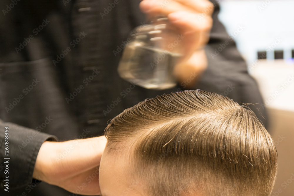Fototapeta premium Hairdresser cutting hair. Hairdresser at work cutting customers hair