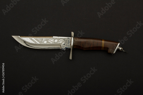 Curved ceremonial dagger with ornate sheath on a black background.Hunting dagger knife with decorative shell isolated on a  background. Vintage dagger on  background. Dagger mockup on white.