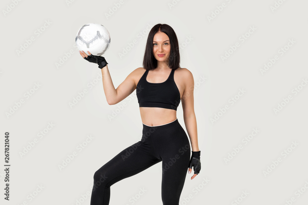beautiful athletic woman with soccer ball posing isolated on gray background beautiful athletic woman with soccer ball posing isolated on gray background
