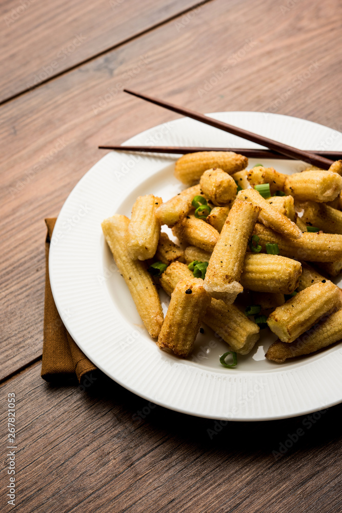 Baby Corn Manchurian dry - popular Indo-chinese starter recipe. selective focus Baby Corn Manchurian dry - popular Indo-chinese starter recipe. selective focus