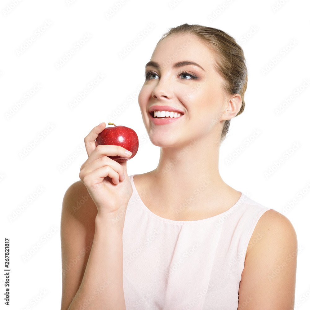 Beauty female portrait. Young attractive woman posing at studio with apple over white background. Beautiful girl with perfect smile. Model with perfect make-up Beauty female portrait. Young attractive woman posing at studio with apple over white background. Beautiful girl with perfect smile. Model with perfect make-up