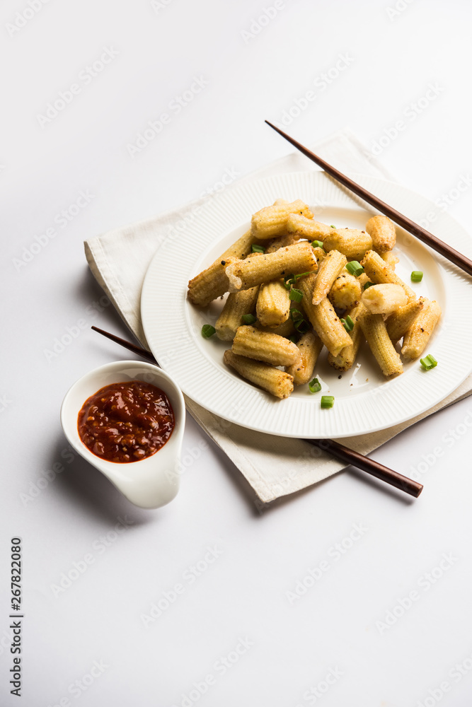 Baby Corn Manchurian dry - popular Indo-chinese starter recipe. selective focus Baby Corn Manchurian dry - popular Indo-chinese starter recipe. selective focus
