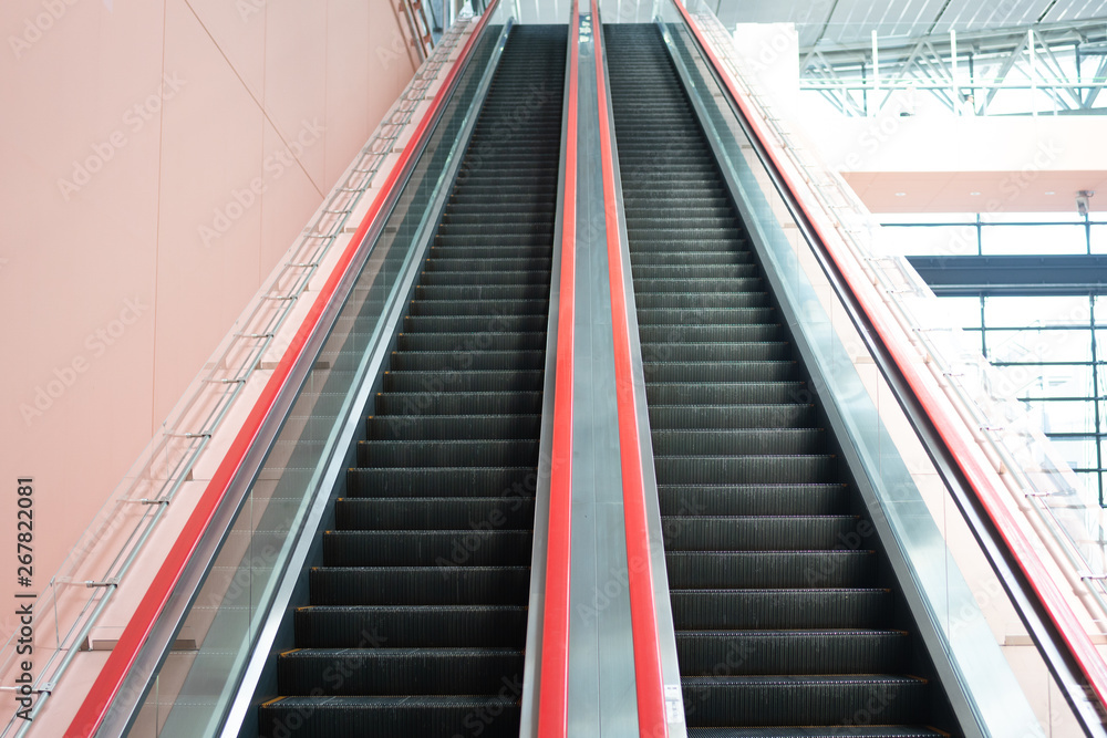 Escalator in shopping mall. Moving up and down staircase. electric escalator. Escalator in shopping mall. Moving up and down staircase. electric escalator.