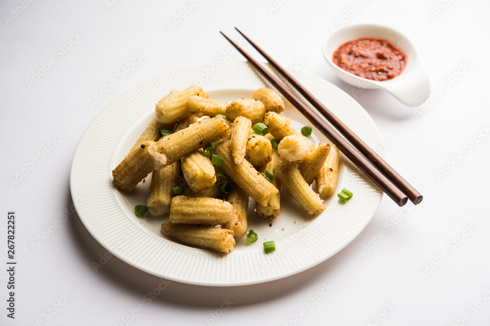 Baby Corn Manchurian dry - popular Indo-chinese starter recipe. selective focus Baby Corn Manchurian dry - popular Indo-chinese starter recipe. selective focus