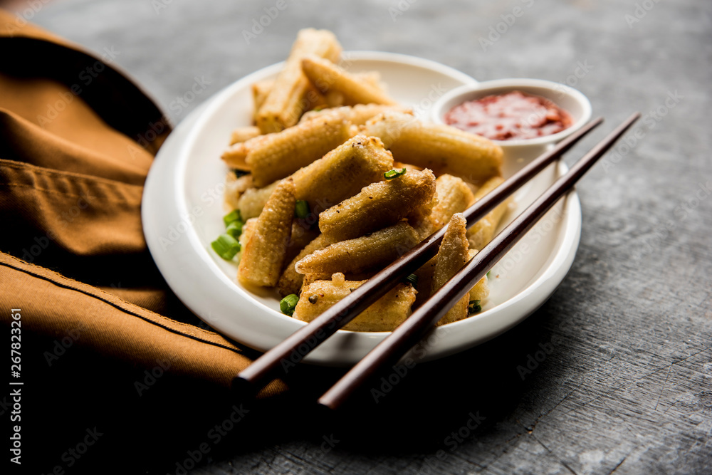 Baby Corn Manchurian dry - popular Indo-chinese starter recipe. selective focus Baby Corn Manchurian dry - popular Indo-chinese starter recipe. selective focus