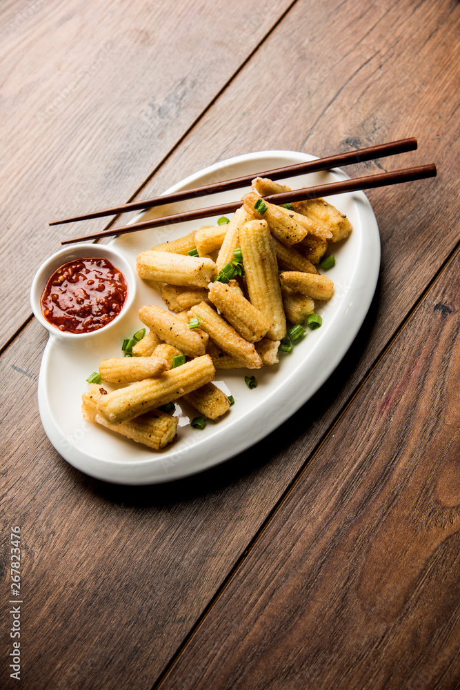 Baby Corn Manchurian dry - popular Indo-chinese starter recipe. selective focus Baby Corn Manchurian dry - popular Indo-chinese starter recipe. selective focus