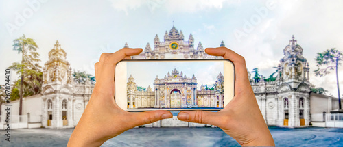 Tourist taking a picture in front of   Dolmabahce Palace Istanbul, Turkey. Travel concept photo