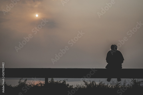 Men sitting on the roadside.