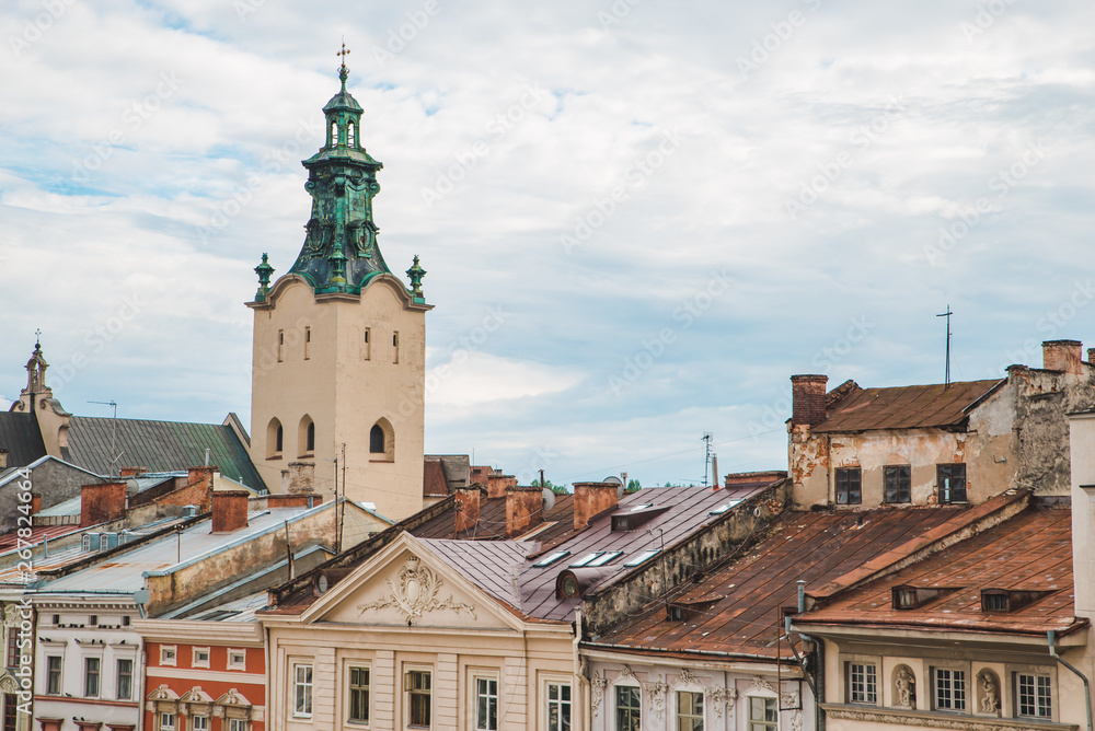 church tower over old building roofs. overcast weather