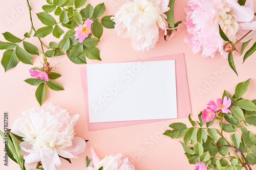 Mockup wedding invitation and envelope with pink peonies on a pink background © maria_lh