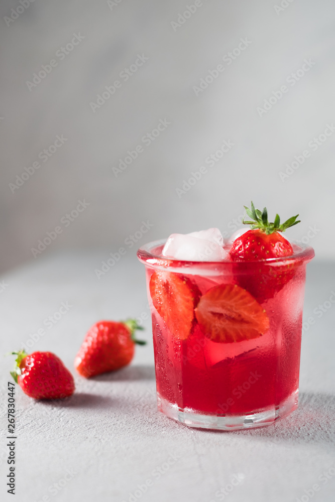 Srawberry soda drink with ice on grey background. Srawberry soda drink with ice on grey background.