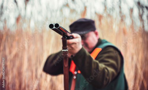 Hunter with a rifle in hunting