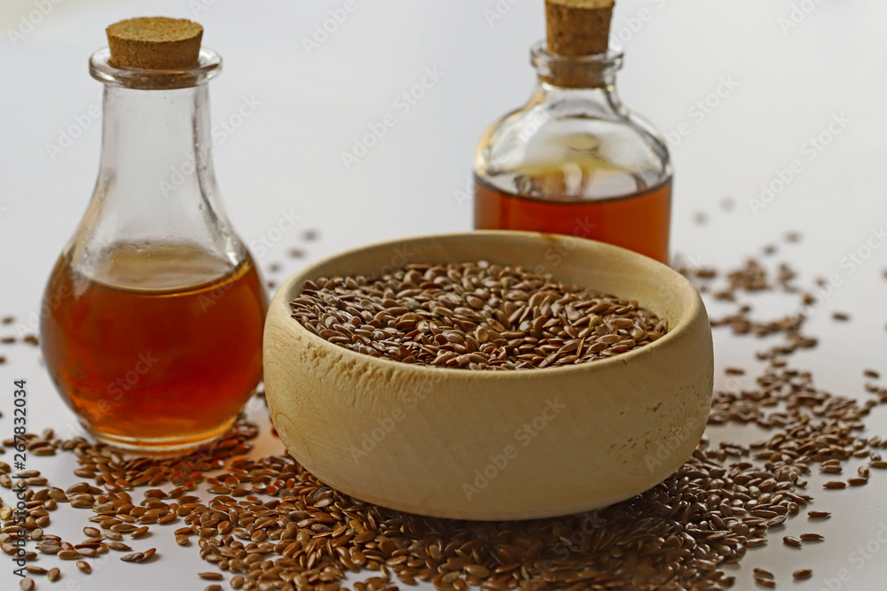 Sesame seeds in bowl and sesame oil in bottle Sesame seeds in bowl and sesame oil in bottle