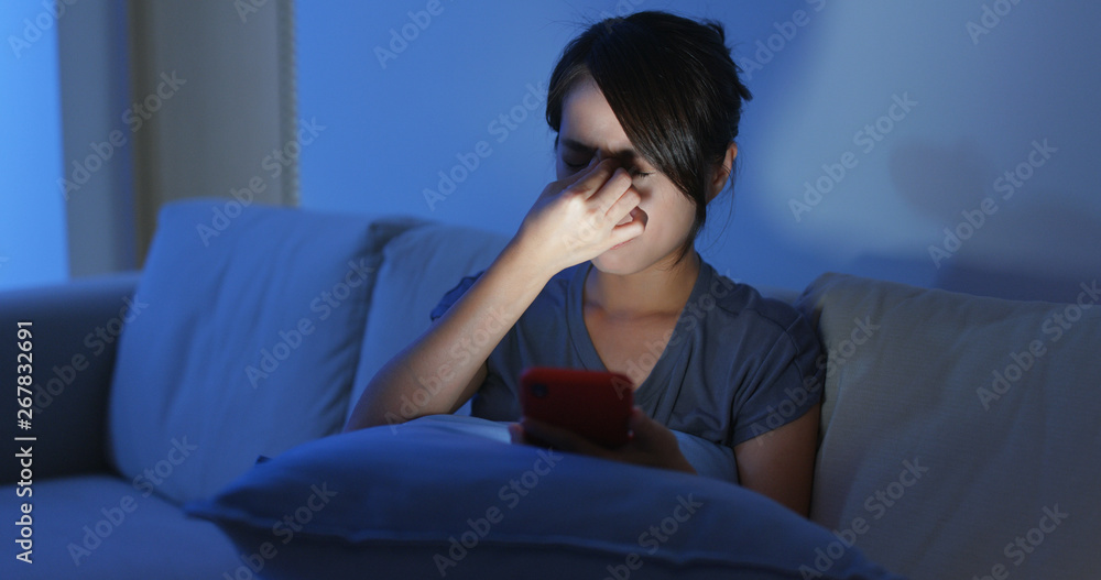 Woman look at the cellphone for a long time and rubbing on her eye Woman look at the cellphone for a long time and rubbing on her eye