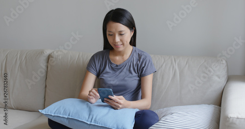 Asian woman use of mobile phone at home