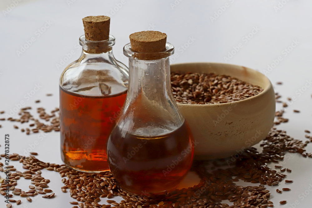 Sesame seeds in bowl and sesame oil in bottle Sesame seeds in bowl and sesame oil in bottle