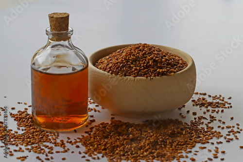 Sesame seeds in bowl and sesame oil in bottle