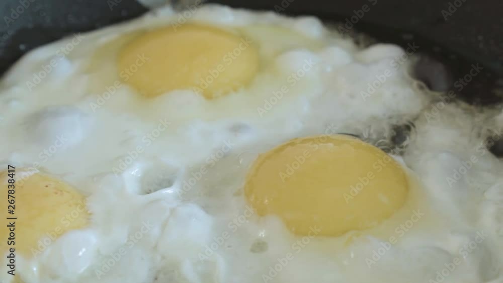 the fried eggs cooked on a pan close up the fried eggs cooked on a pan close up