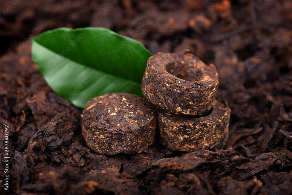 Aromatic black pu-erh tea. Fermented and compressed Leaves into bricks. Round flat disc of puer tea. Healthy drink. Aromatic black pu-erh tea. Fermented and compressed Leaves into bricks. Round flat disc of puer tea. Healthy drink.