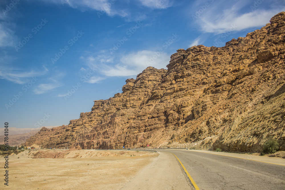 empty car road country side transportation object in Middle East desert outdoor environment along sand stone rocky mountain ridge empty car road country side transportation object in Middle East desert outdoor environment along sand stone rocky mountain ridge