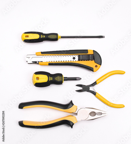 Black yellow tools - knife, pliers, tape measure, screwdriver, nippers on a white background. Place for text. Work inventory