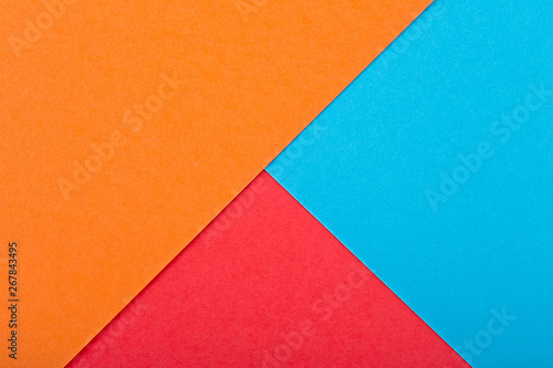 Colored paper texture. Geometric figure. Red color, orange color and blue color.
