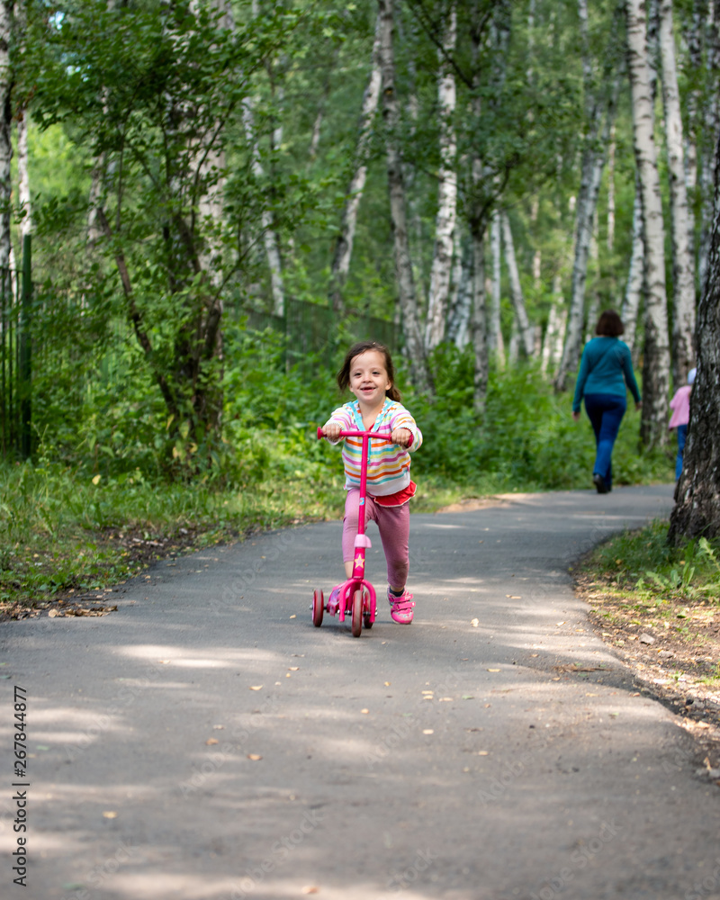 child riding a scooter