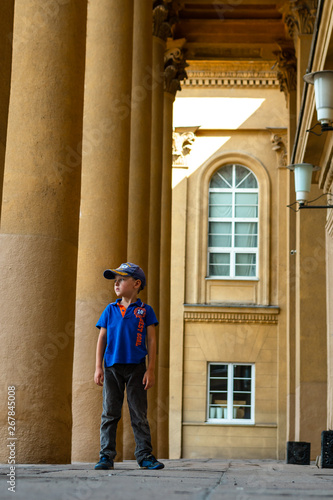 the child is standing near a column © EvgenyPyatkov