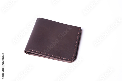 Brown handmade leather wallet isolated on white background. Wallet is closed. Stock photo of luxury businessman accessories.