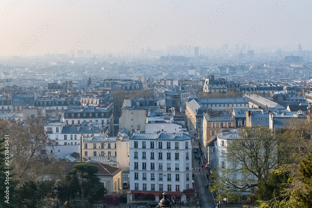 Paris, panorama of the city, from Montmartre hill, typical roofs, in the mist