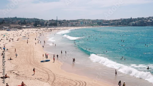 People relaxing and sunbathing at Bondi beach in Sydney, Australia photo