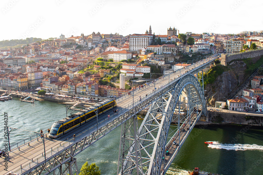 Aerial view of Dom Luis I Bridge with metro train across Douro River, the famous postcard of Porto, Portugal