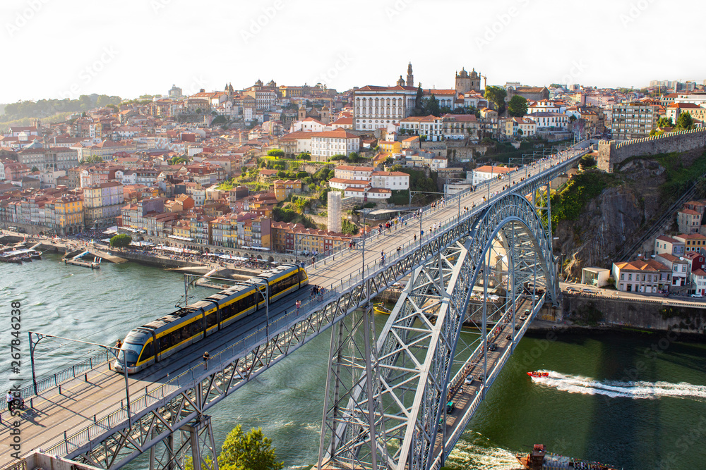 Aerial view of Dom Luis I Bridge with metro train across Douro River, the famous postcard of Porto, Portugal