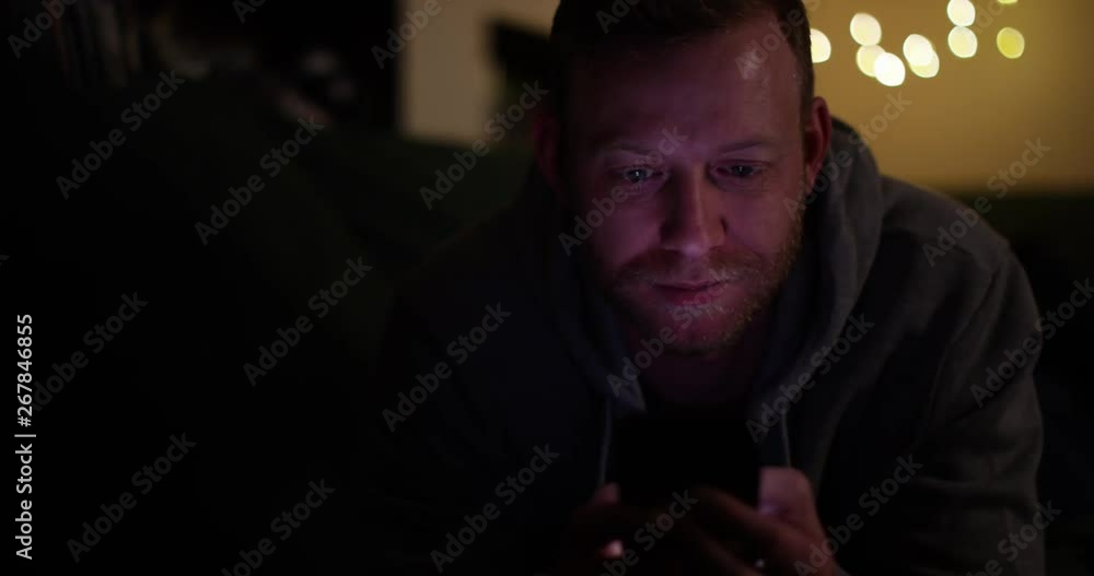 4k, A young attractive man engrossed in playing games on a touchscreen tablet. Slow motion 4k, A young attractive man engrossed in playing games on a touchscreen tablet. Slow motion