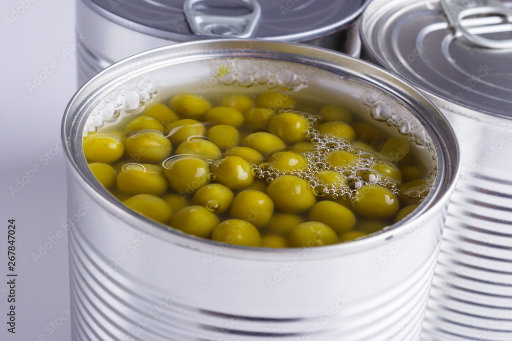 Canned green peas in a iron can on white background Canned green peas in a iron can on white background