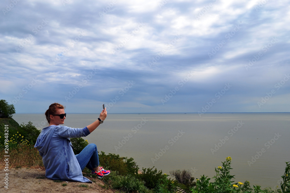 lifestyle, leisure, summer, technology and people concept - smiling young woman or teenage girl in sun hat taking selfie with smartphone on beach lifestyle, leisure, summer, technology and people concept - smiling young woman or teenage girl in sun hat taking selfie with smartphone on beach