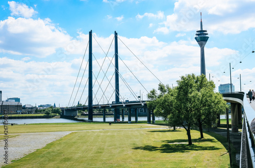 Landscape of Oberkasseler bridge and the Television Transmission Tower in Düsseldorf, Germany on a sunny summer day. © Anna